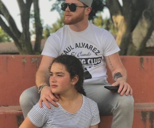 Emily Cinnamon Alvarez posing with her father Canelo Alvarez for a photoshoot. 